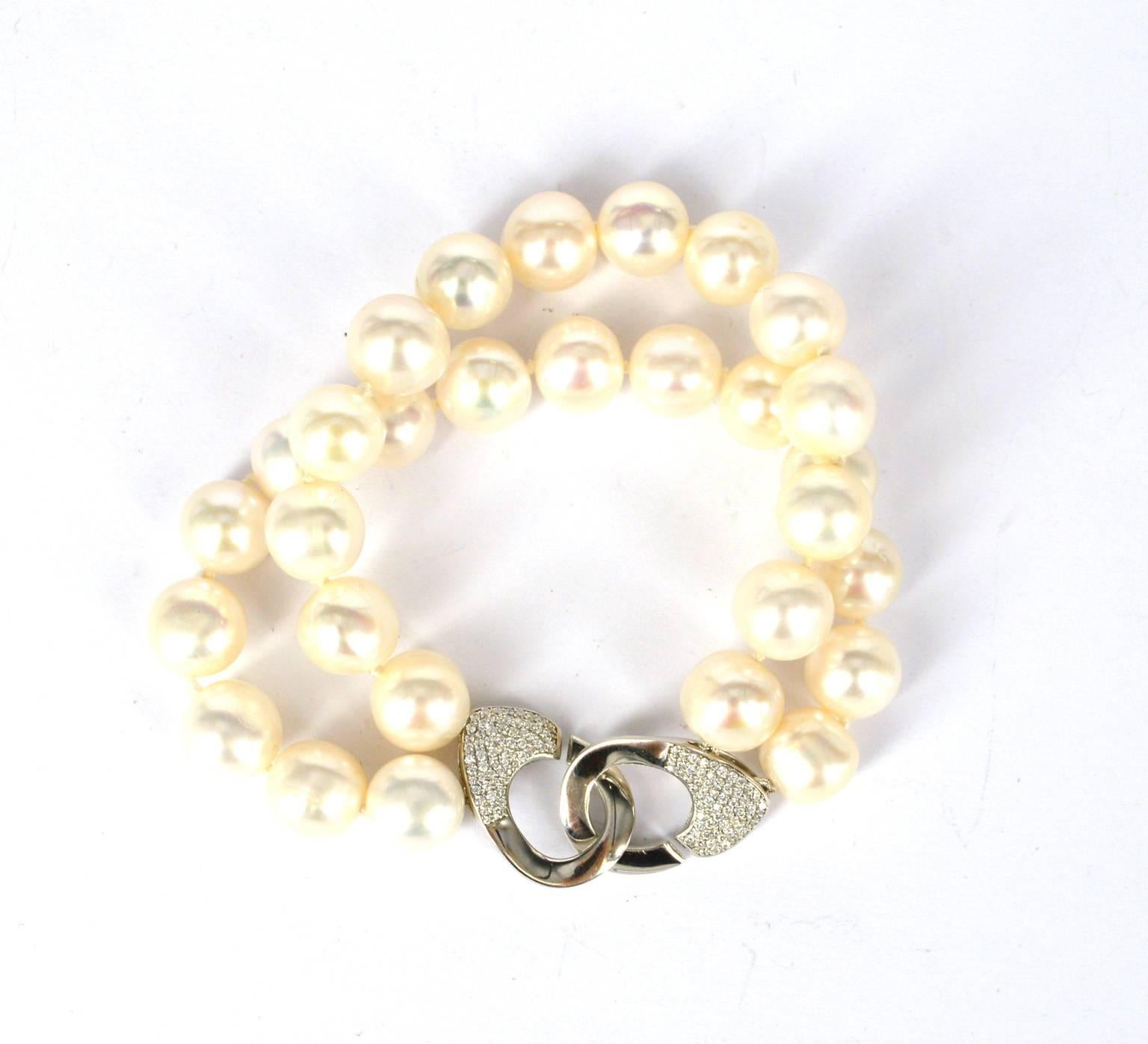 2 strands of nearly round 11mm Fresh water white pearls, rhodium plate Sterling Silver CZ clasp.
Fits wrist size 17cm. 
19.5cm in length