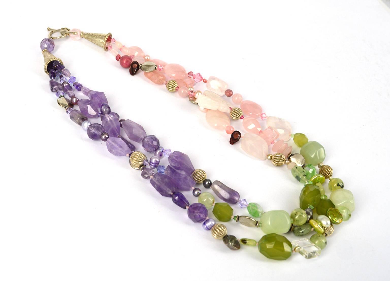 3 Strand torsade Necklace made up of various shapes and stones. Rose quartz swarovski freshwater pearls prehnite chalcedony amethyst and silver plated copper.
56cm in length