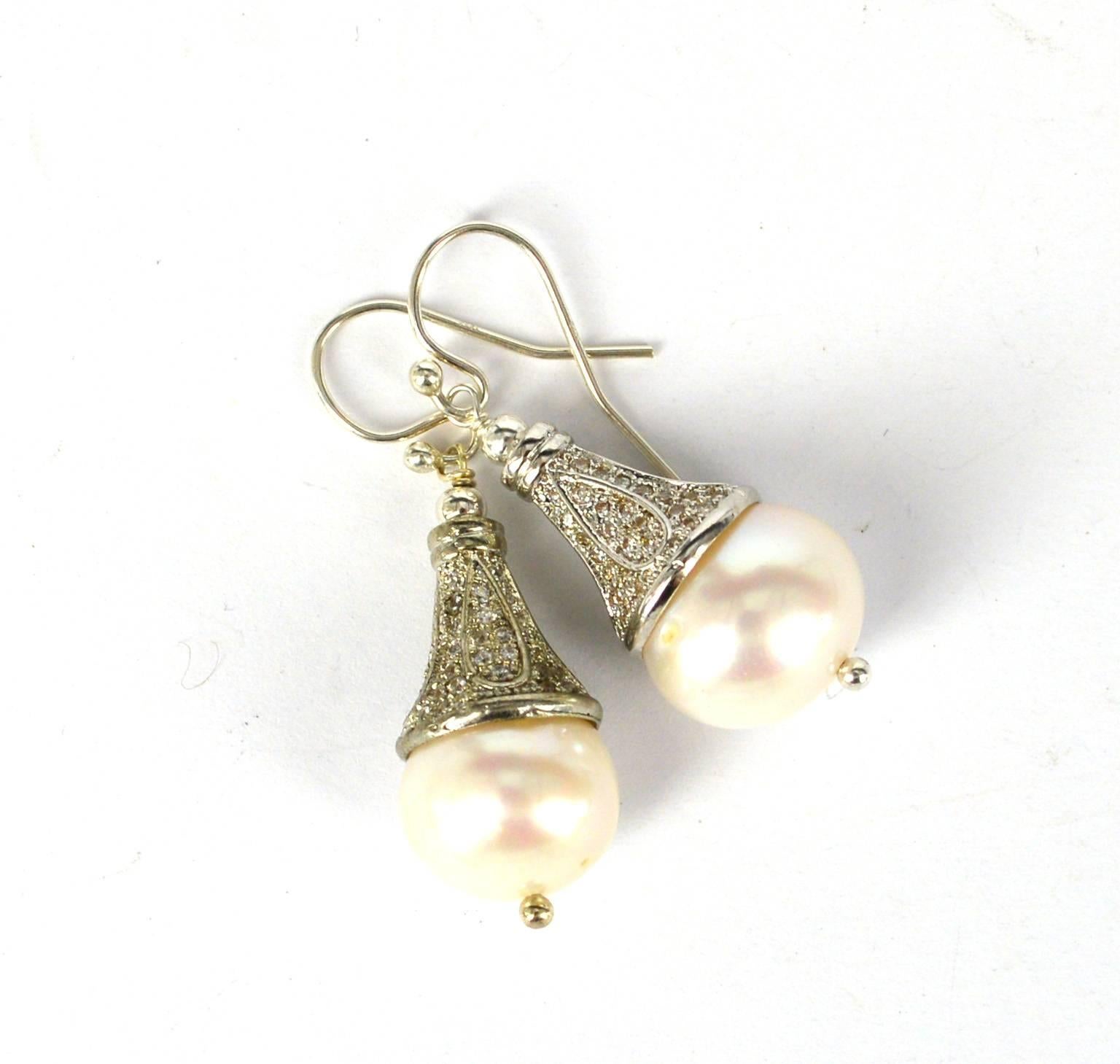 Victorian style natural pearl earrings. Rhodium plated CZ cone with an 11mm white fresh water pearl.
36mm drop earring 
Sterling Silver hook, headpin and 3mm bead.