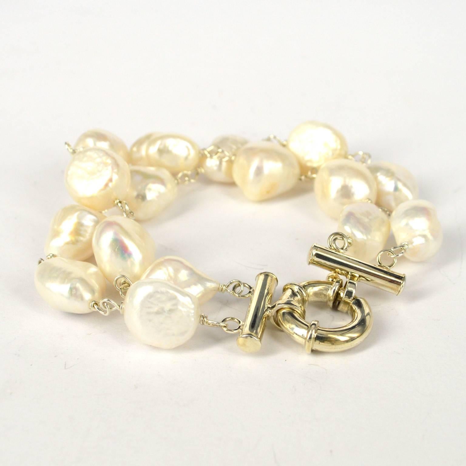 Double strand of baroque fresh water pearls in wire wrapped in 925 Sterling Silver. 
Pearls are approx. 16mm 
Total length of bracelet 22cm
Sterling Silver bolt clasp