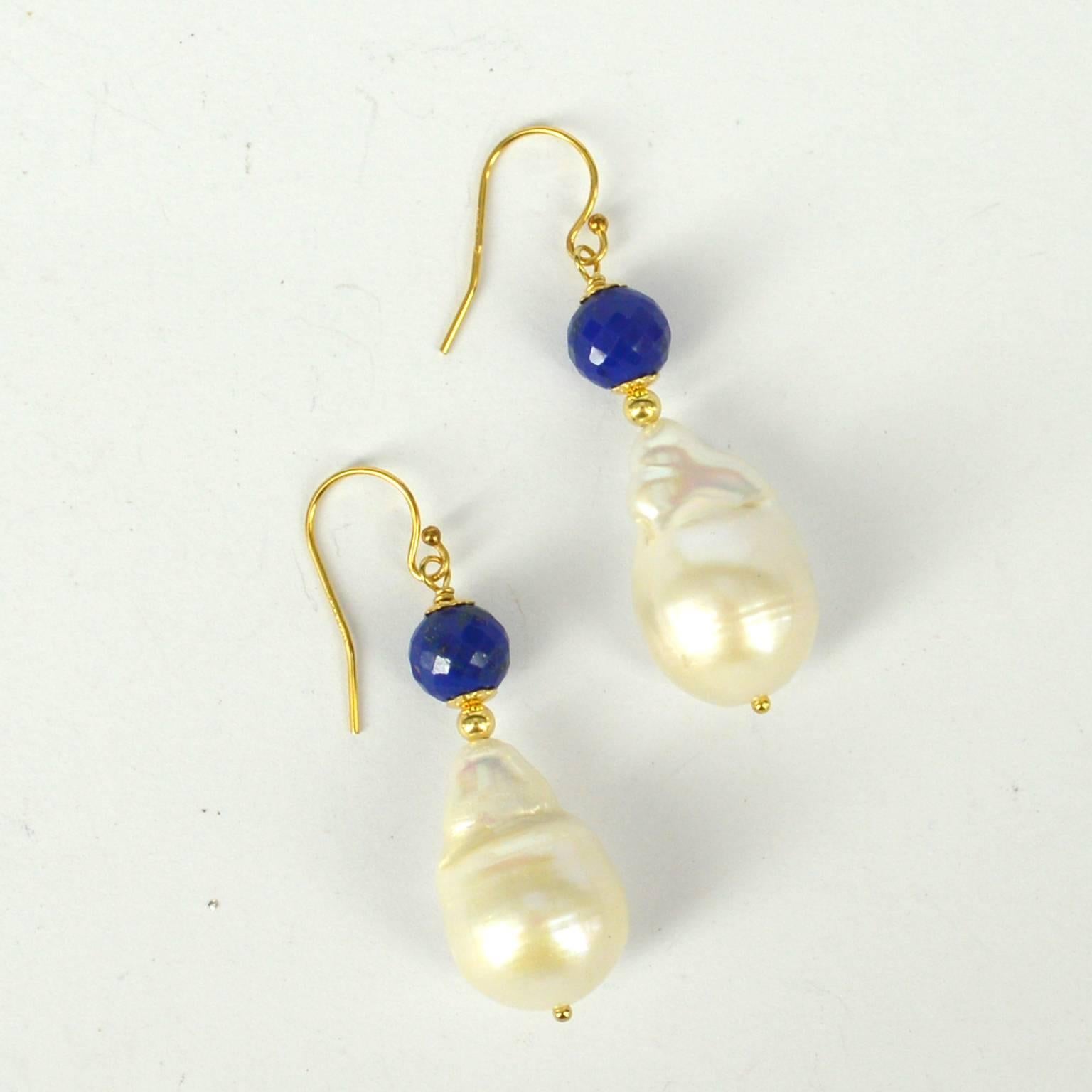 Beautifully multi faceted 8mm Lapis Lazuli sit above a tear drop Baroque Fresh Water Pearl 13x21mm.
All findings are 14k Gold Filled 
Total Earring length is 49mm
