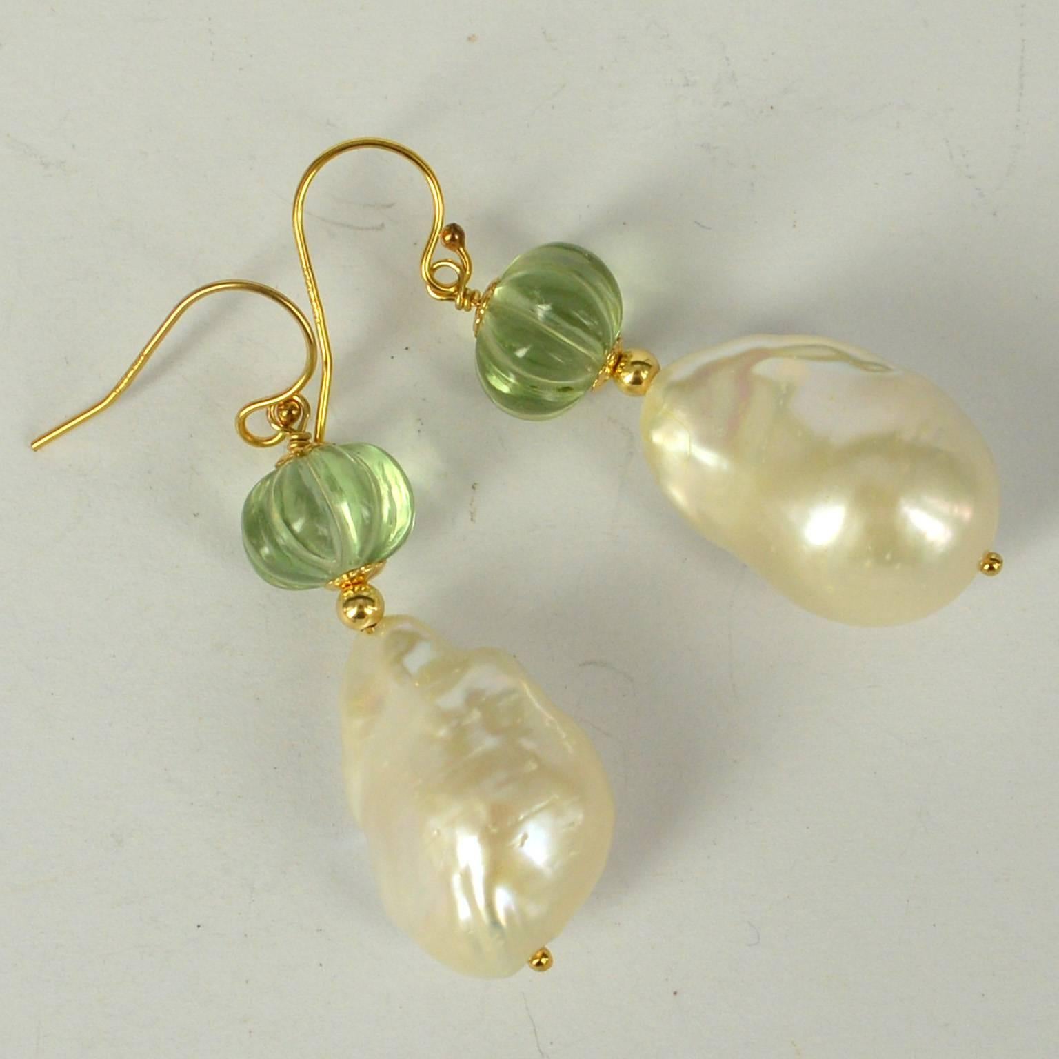 Stunning hand carved melon Shaped Green Amethyst with a high Quality Baroque Fresh Water Pearl.
Green Amethyst Beads measure 10x8mm with a 15x23mm Pearl.
All findings are 14k Gold Filled
length of Earrings is 49mm