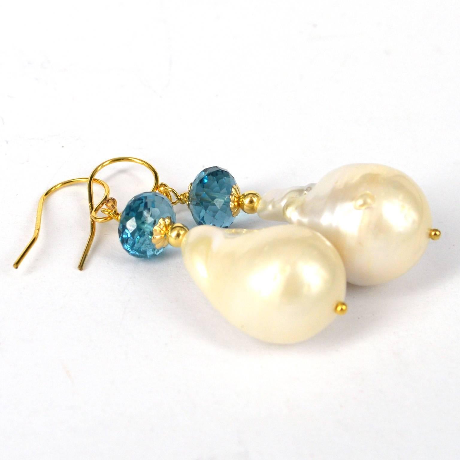 Vibrant deep blue combined with large Baroque Pearls these earrings are a statement.
London Blue Topaz stones 8x6mm with a 22x15mm Pearl, all findings are 14k Gold Filled.
Total length of earrings is 45mm