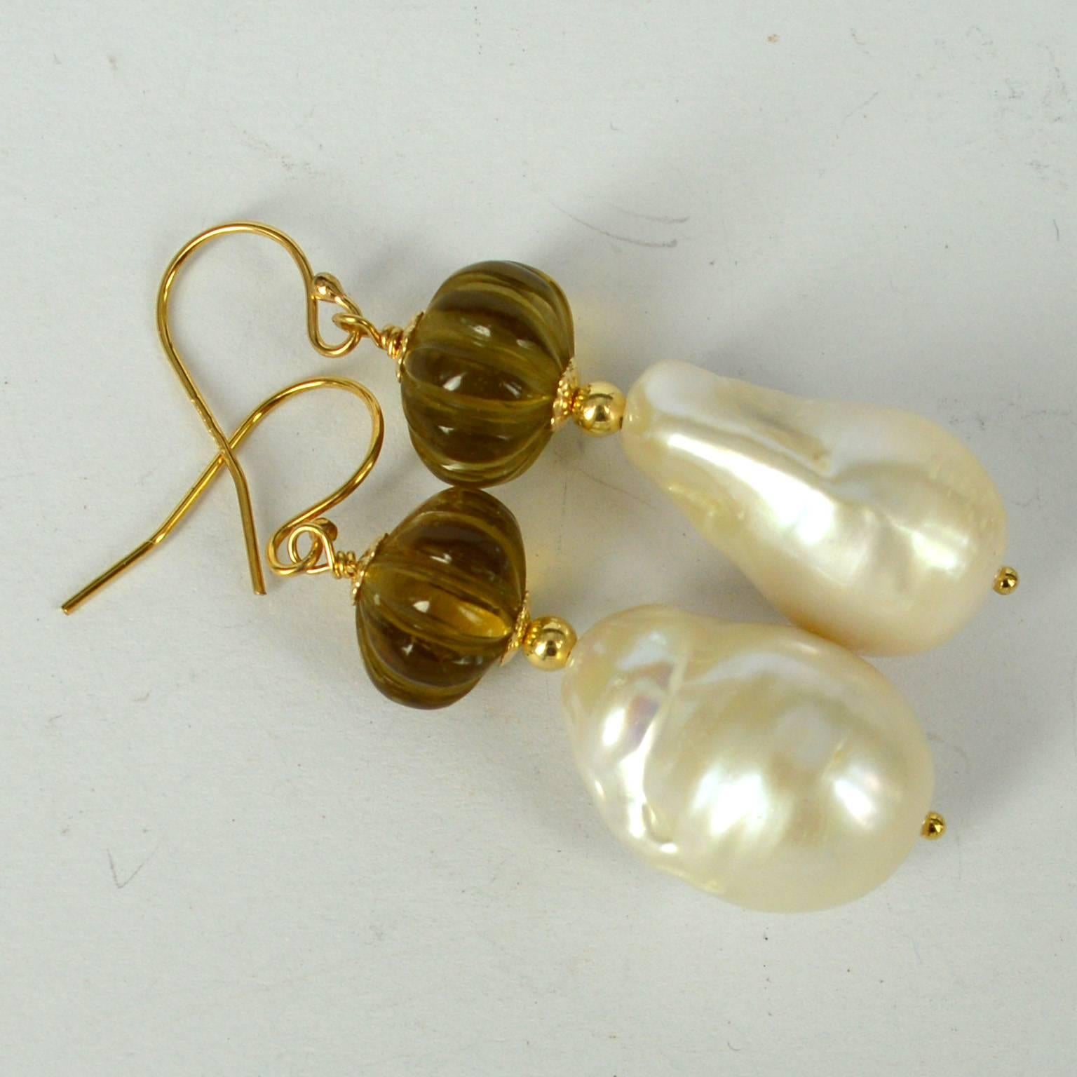 Stunning hand carved melon Shaped Beer Quartz with a high Quality Baroque Fresh Water Pearl.
Beer Quartz Beads measure 11x8mm with a 14x20mm Pearl.
All findings are 14k Gold Filled
length of Earrings is 47mm