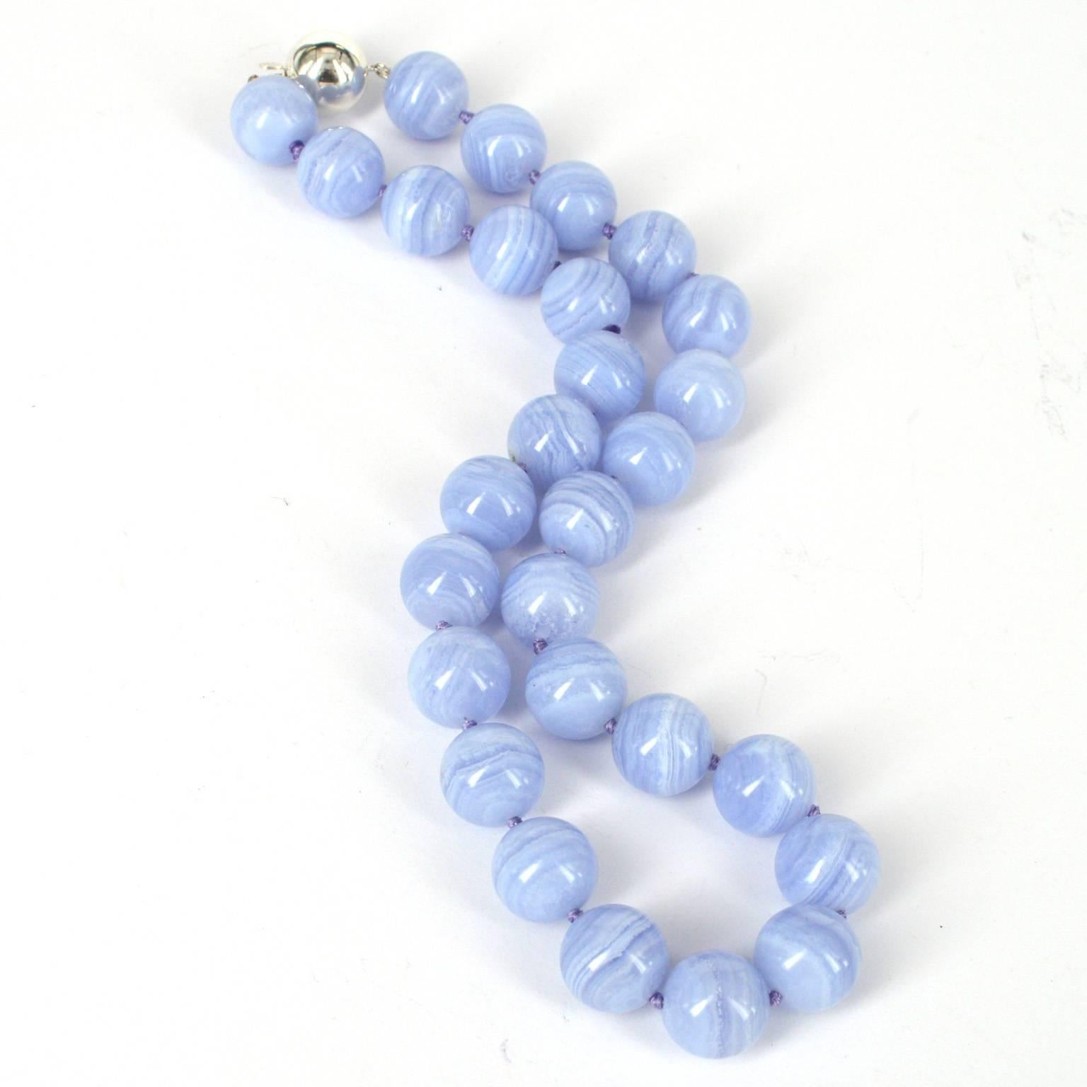 Statement strand of 28 high quality 14mm polished Blue Lace agate beads hand knotted on matching blue thread with a 14mm round Sterling Silver clasp. 
Finished necklace measures 46cm.
Matching bracelet and Earrings can also be ordered, necklace