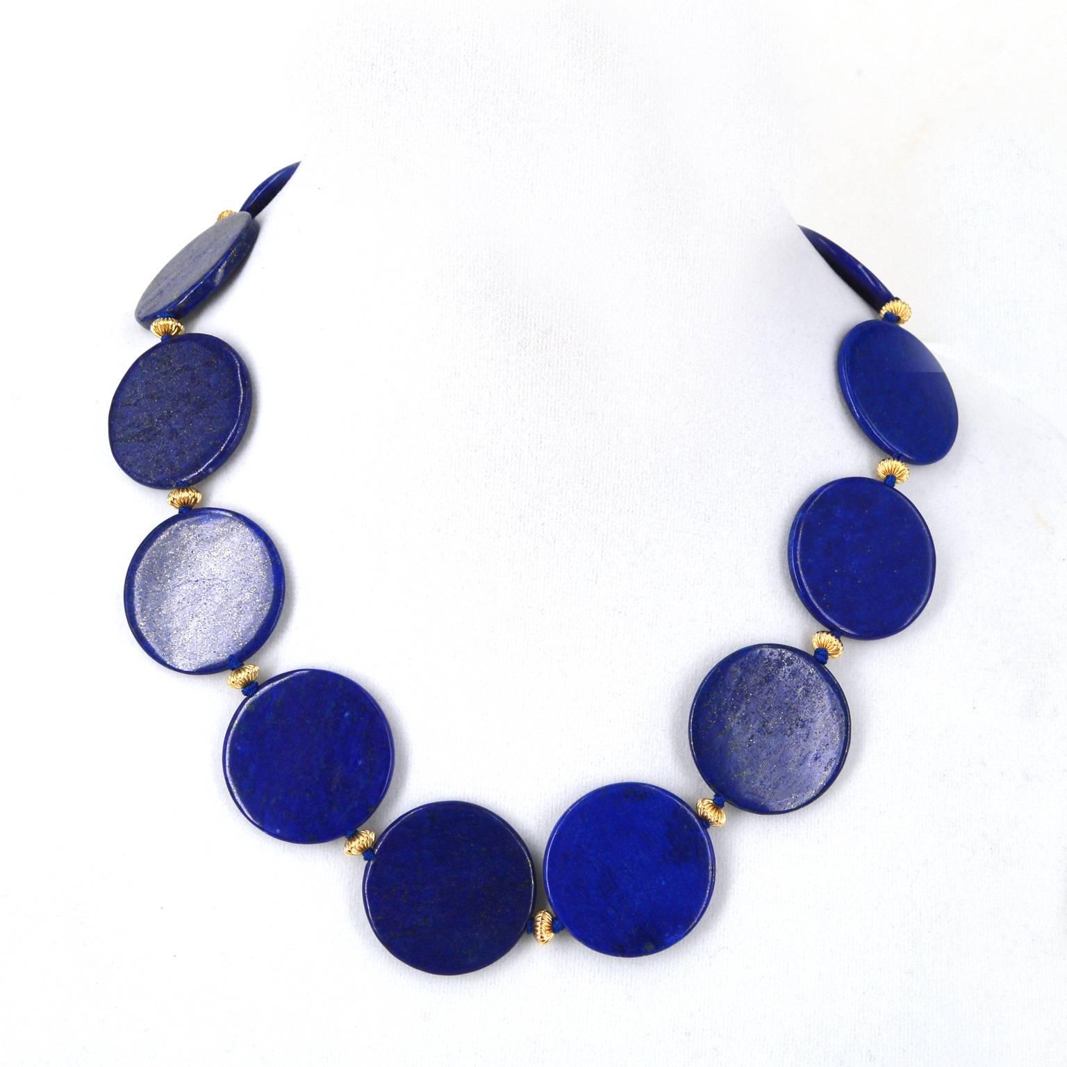 30mm polished flat disk Lapis Lazuli beads hand knotted on blue thread with 14k gold filled corrugated roundels and a 14k gold filled corrugated 14mm round clasp.
Total length of necklace 48cm.

