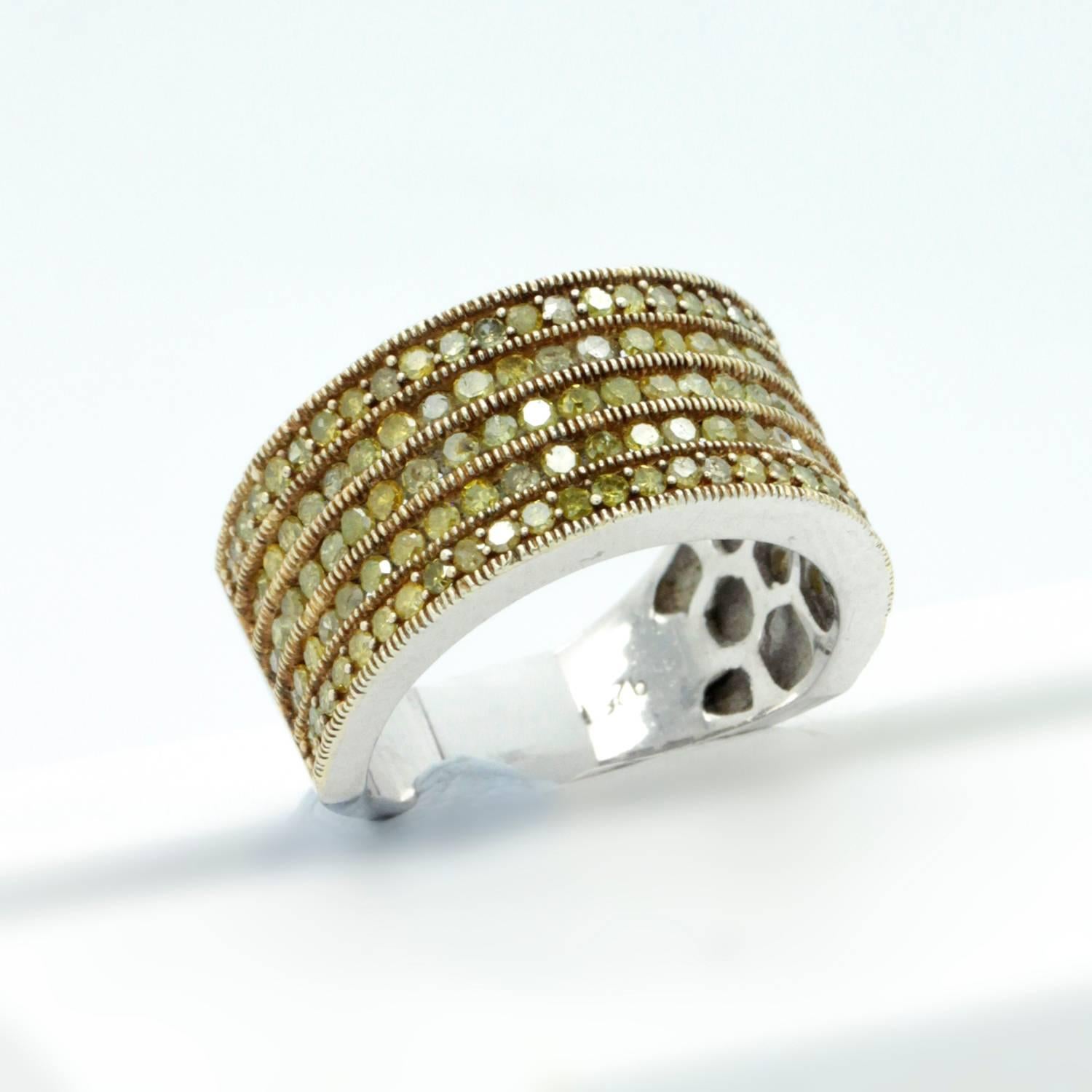 A Sterling Silver Yellow Diamond wedding band or cocktail ring.  A very nice ring for either hand, for any reason.  the Yellow / Chartreuse Diamonds have Rose yellow gold bead accents to draw out the colour.  While they are included stones, the