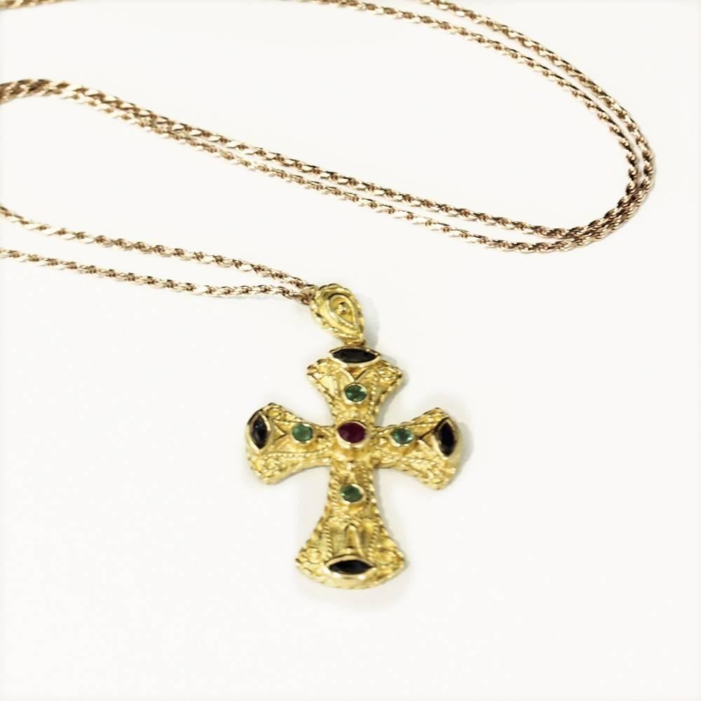 Beautiful multi-stone 18ct yellow gold cross pendant,  Handmade 18ct yellow gold cross pendant featuring Natural Emeralds, Ruby and Sapphires.  Stunning value!  A free Gold chain will be included.

Dimensions:
Cross (including bale) - 36mm x