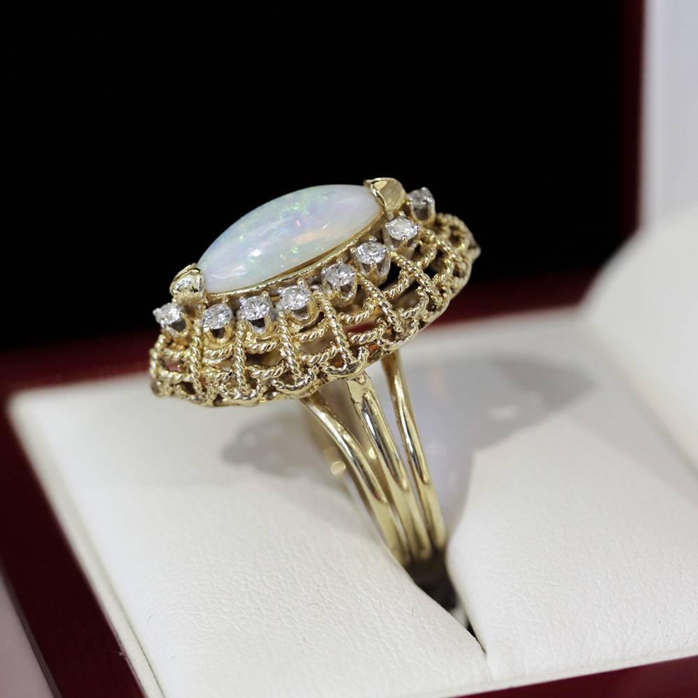 Stunning vintage Marquise shape Opal and Diamond Cocktail ring, Cluster ring. 

14ct yellow gold (acid tested) 15 stone Opal and Diamond cluster ring. Marquise cabochon Opal end cap set surrounded by 14 round brilliant cut Diamonds rhodium tip 4