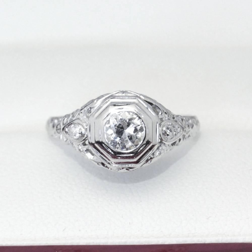 Beautiful Art Deco filigree Diamond and white gold engagement ring

18ct white gold 3 stone Diamond ring. Semi modern cut Diamond pressure set with a hexagonal surround with 1 single cut Diamond gran set in pear shape each side with filigree pierced