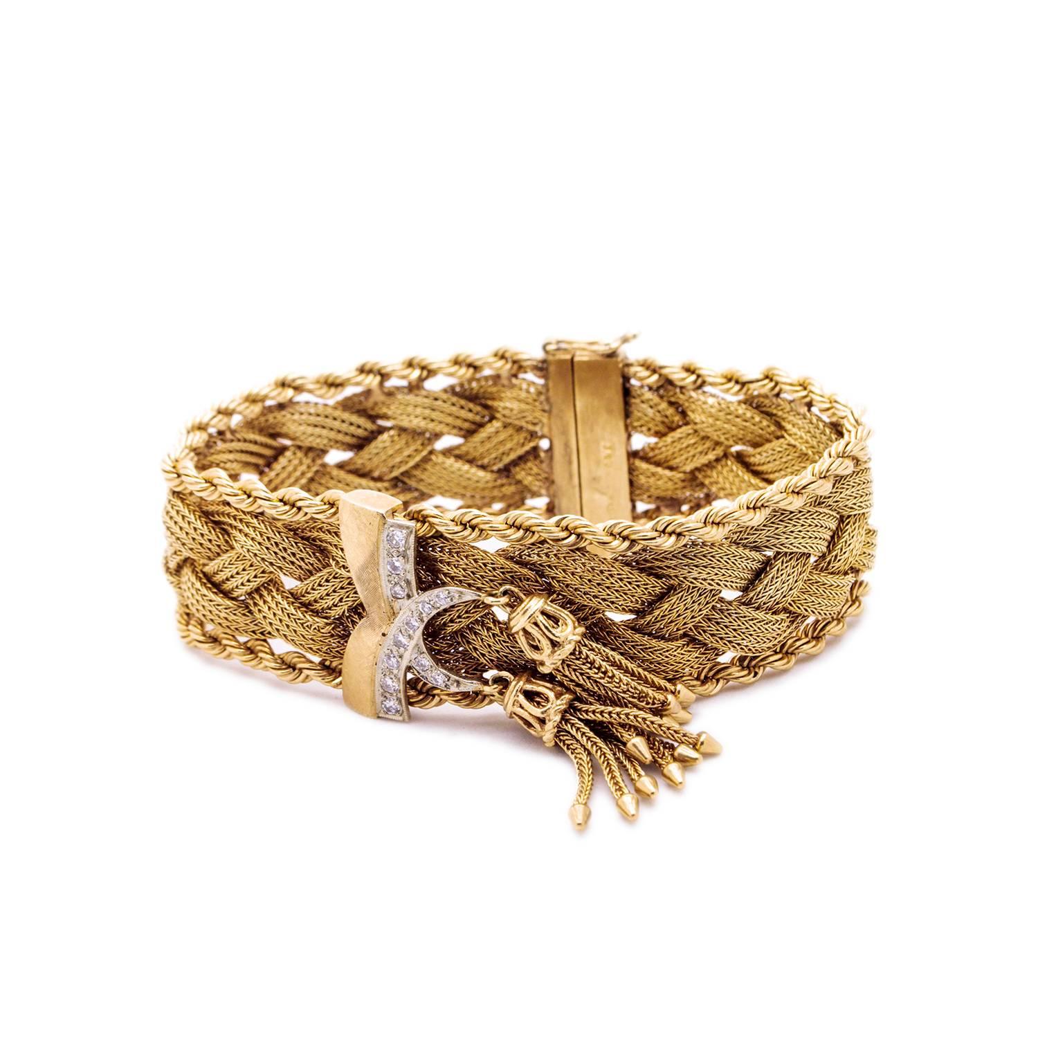 Vintage Gold and Diamond Bracelet,  featuring 12 Early Brilliant cut Diamonds and hanging tassels

14ct yellow gold 12 stone Diamond bracelet. 20mm wide 3 row mesh braided gold strands with rope embellishment on each side with center satin finish, V