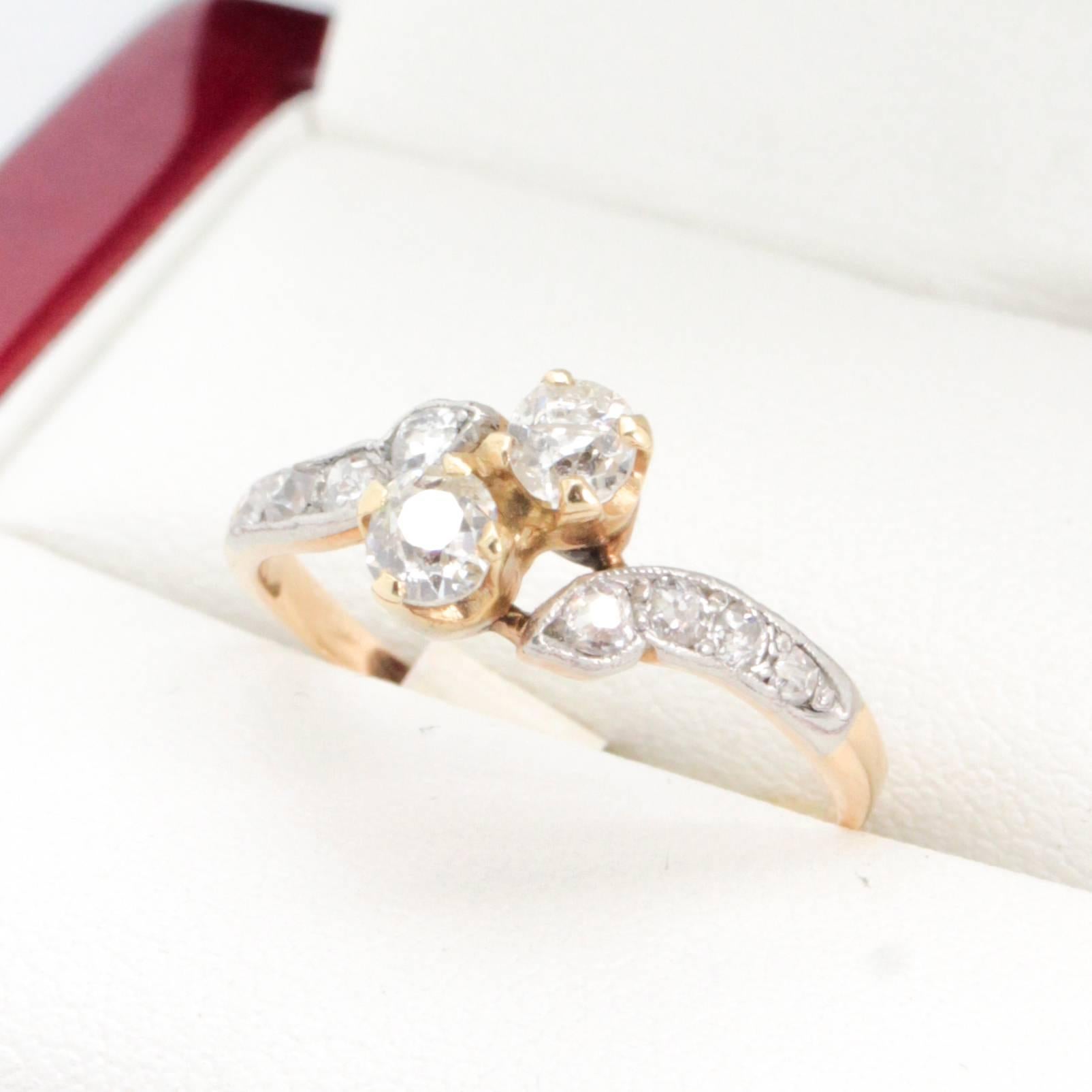 Art Deco Antique Diamond Engagement ring, with beautiful crossover 14ct gold setting. Circa 1930.

14ct yellow gold and platinum (acid tested) 10 stone Diamond ring. 2 old cut diamonds 4 claw set diagonally with 4 old cut Diamonds platinum top