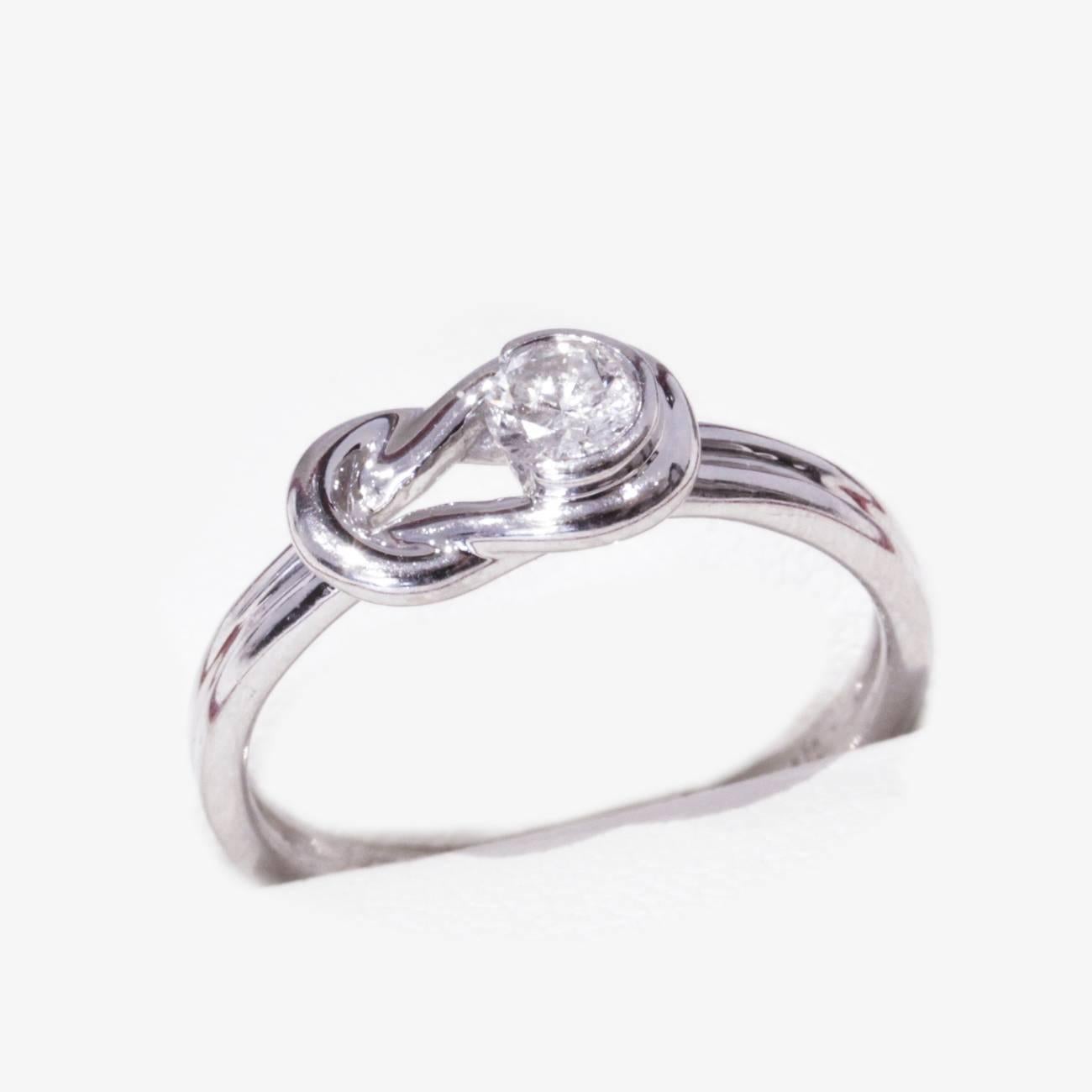 Very Lovely Knot style, vintage white gold Engagement ring, featuring a brilliant cut Diamond
-
14ct White gold single stone Diamond Engagement ring. Round brilliant cut Diamond part rub over set in a love knot surround in a grooved 2.4mm