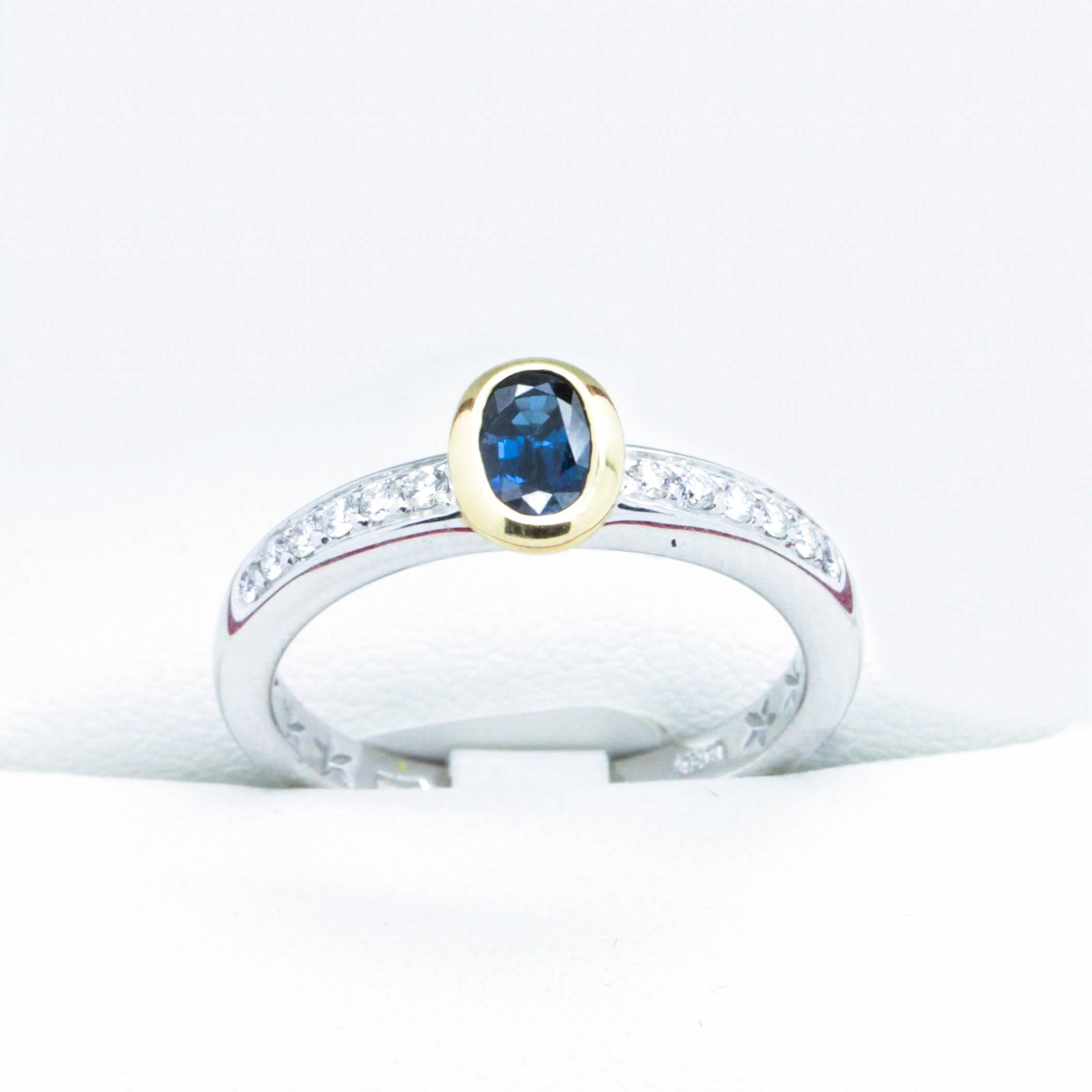 Sapphire and Diamond 18ct Gold Engagement Ring.  Lovely!

A Lovely 18K Yellow and White gold ring, featuring one oval- cut Blue Sapphire with row of Full- cut Diamonds either side of the Sapphire. 

One rub over set oval shaped blue Sapphire, colour