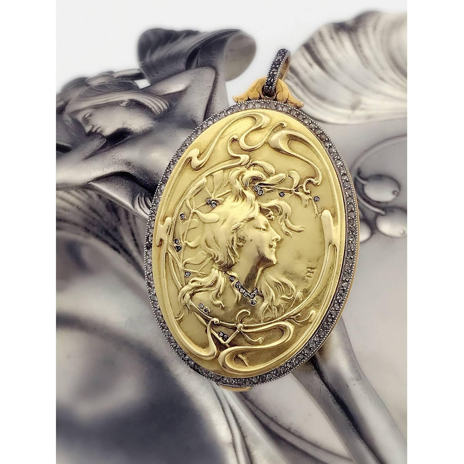 Art Nouveau 18k gold diamond locket. Of oval-shape outline, depicting the profile of a lady with flowing hair, within a diamond point surround, opening to reveal an interior mirror. Locket with Maker's mark for Comte Prosper d'Epinay De Briort,