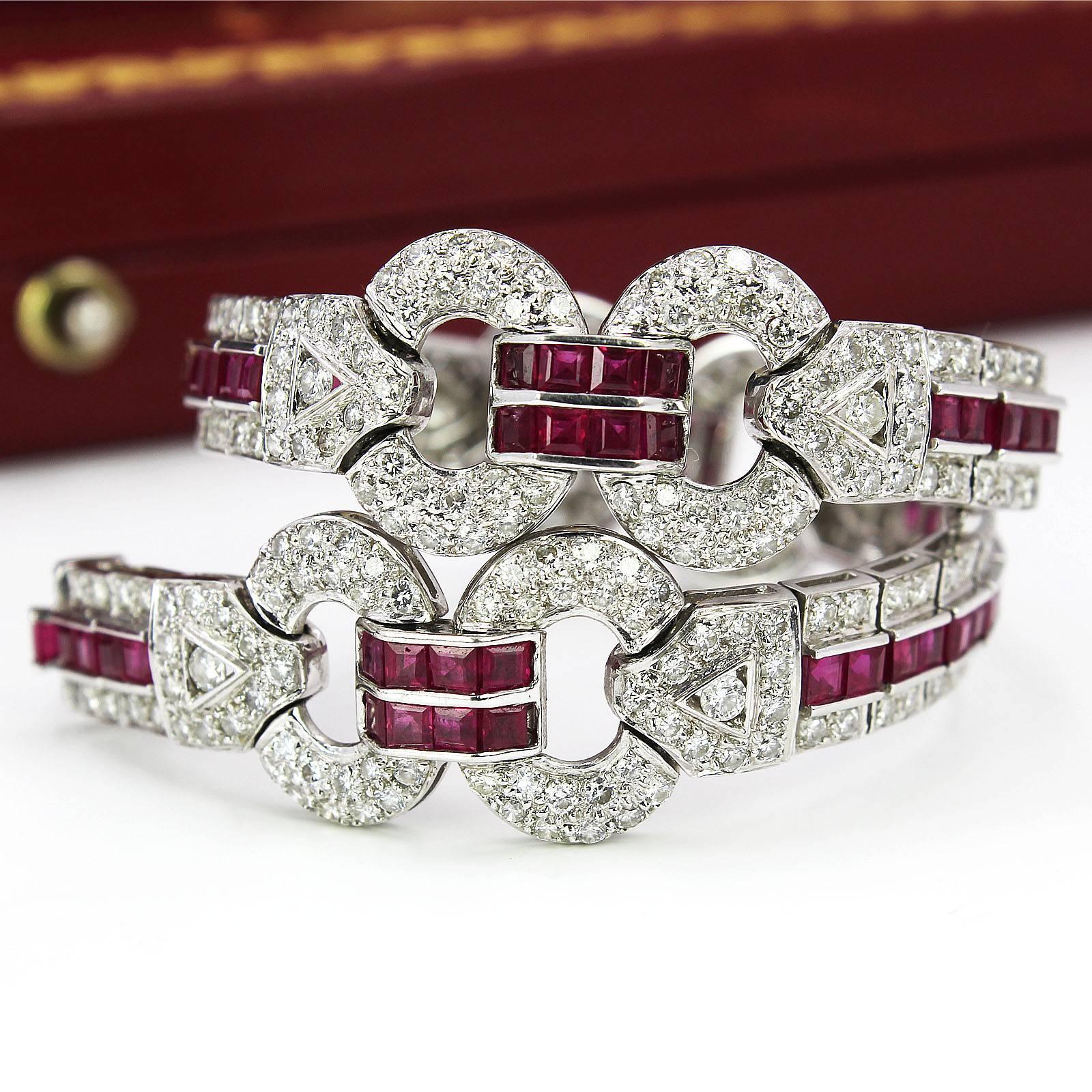 Designed as a series of calibre-cut ruby and brilliant-cut diamond three-row lines, interspaced by similarly-set geometric links, to the concealed clasp. Estimated total diamond weight 4cts. Length 18cms. Weight 26.3gms. With fitted case.