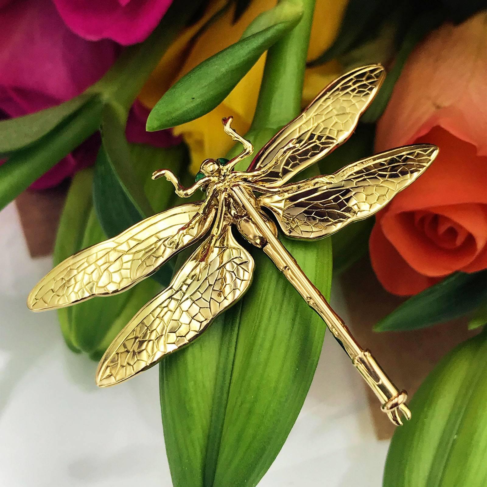 18k yellow gold antique style dragonfly brooch with green enamel wings, set with 0.48ct diamonds accents set in the torso and on the wings and 0.84ct cabochon green emerald body and enamel eyes. 