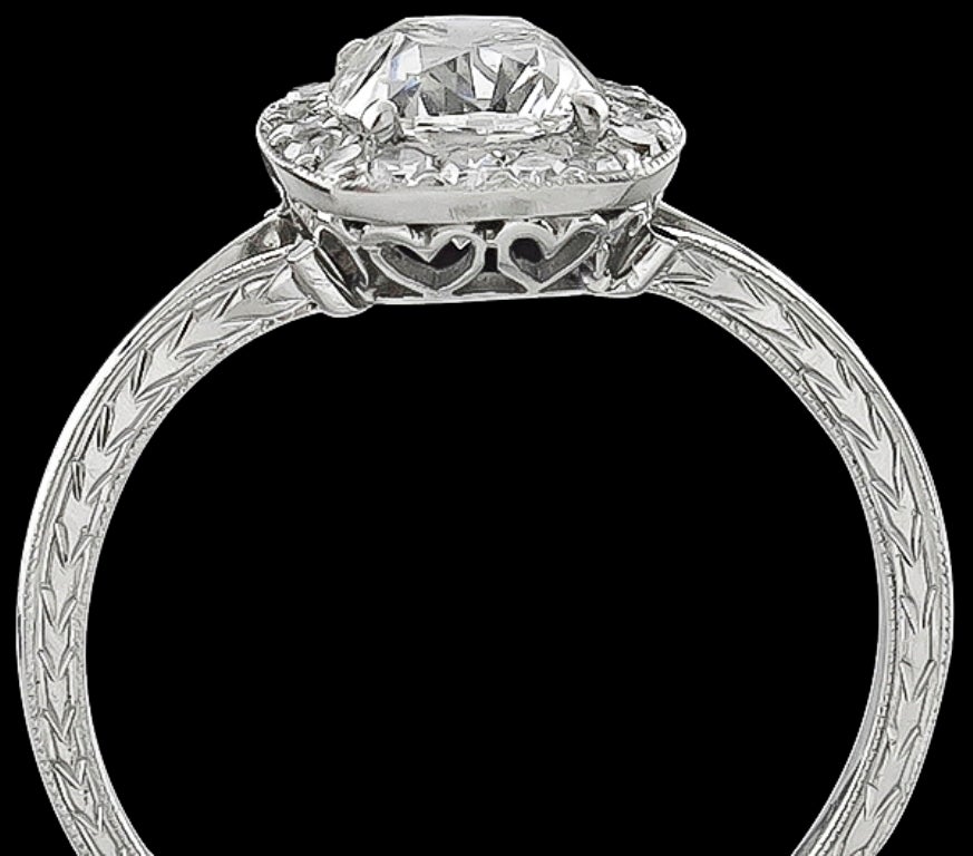 This elegant platinum engagement ring centers a sparkling GIA certified cushion brilliant cut diamond that weighs 1.16ct. and is graded G color with SI2 clarity. The center stone is accentuated by dazzling round cut diamonds weighing approximately