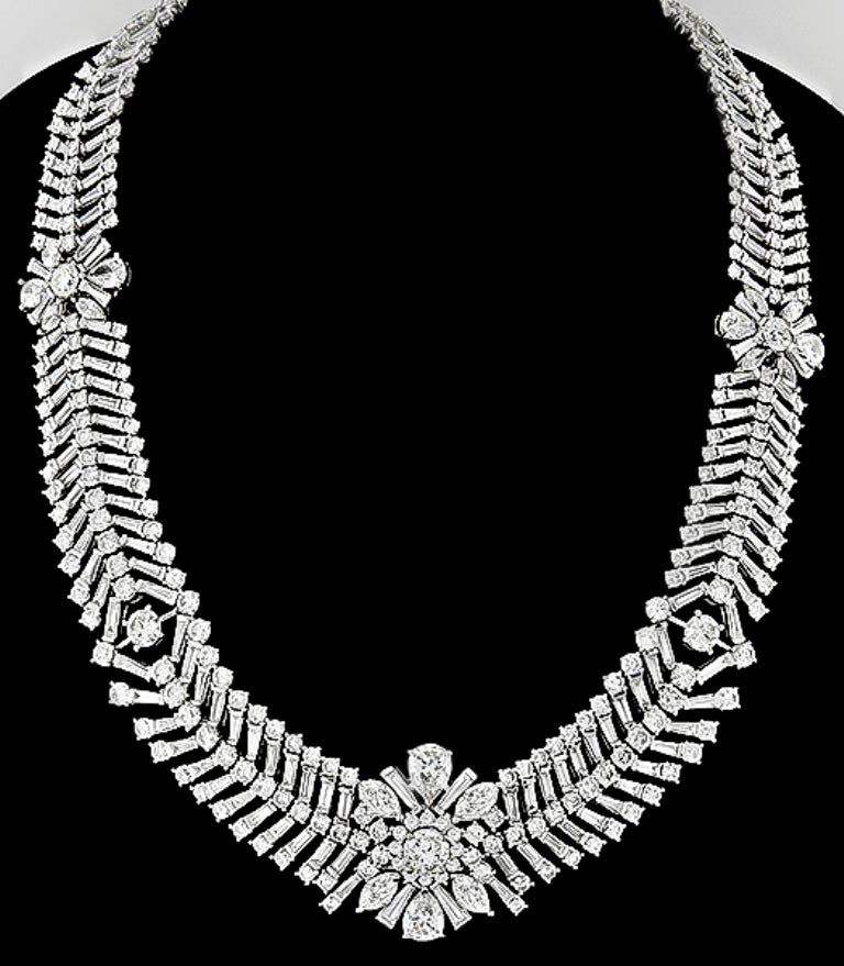 Made of platinum, this set features sparkling baguette, round, pear and marquise cut diamonds that weigh approximately 105.00ct. The color of these diamonds is F-H with VS1-SI1 clarity. The necklace measures 1.22