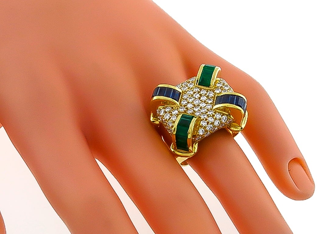 This stunning 18k yellow gold ring is set with sparkling round cut diamonds that weigh approximately 2.00ct. The diamonds are accentuated by baguette cut emeralds and sapphires that weigh approximately 1.25ct and 1.50ct respectively.

The ring is