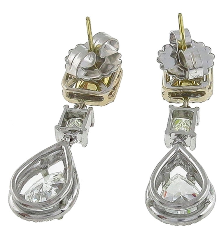 This elegant pair of 14k white and yellow gold earrings feature sparkling GIA certified pear shape cut diamonds that weigh 1.70ct and 1.73ct. The color of these diamonds is I with SI2 and I with I1 clarity respectively. The diamonds are adorned with