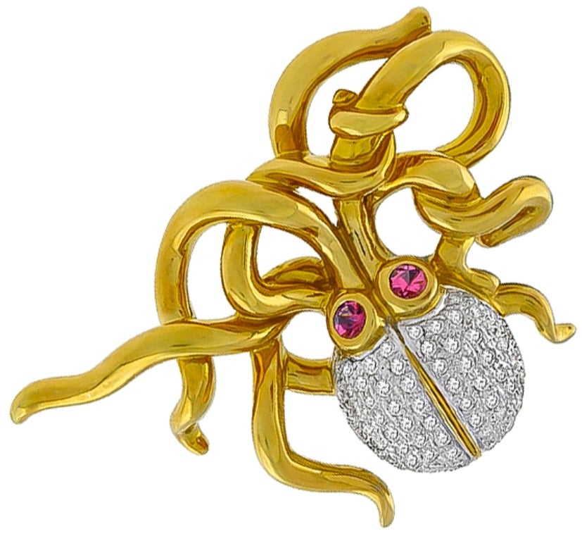This amazing 18k yellow and white gold octopus pin, is set with sparkling round cut diamonds that weigh approximately 1.20ct. The color of the diamonds is H-I with SI clarity. The diamonds is accentuated by two round cut pink sapphires that weigh