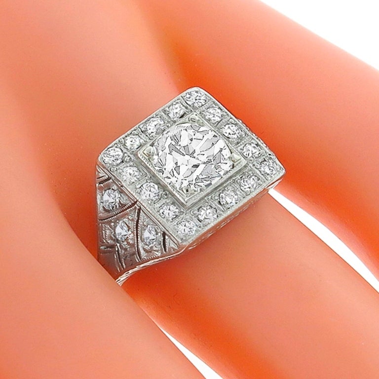Handcrafted from the Art Deco era, this platinum ring centers a GIA certified old mine brilliant cut diamond that weighs 1.24 carat and is graded J color with VS2 clarity. The center stone is accentuated by dazzling old mine cut diamonds that weigh