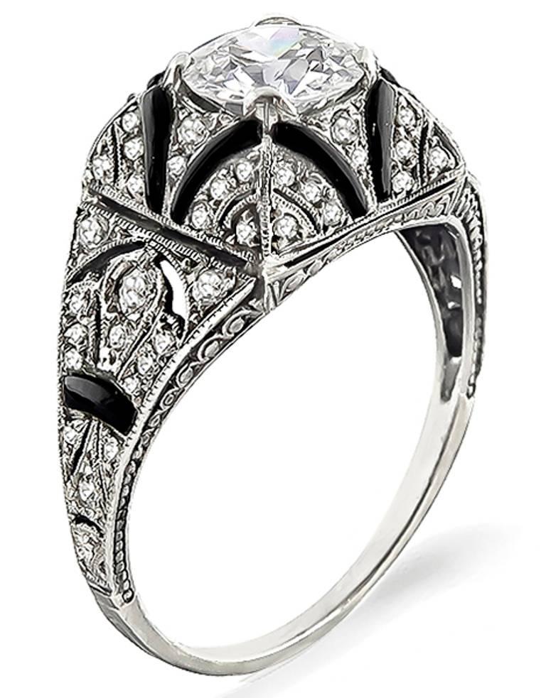 This fabulous platinum engagement ring from the Art Deco era is centered with a sparkling GIA certified old mine cut diamond that weighs 0.99ct. graded G color with SI1 clarity. Accentuating the center stone are high quality diamond accents and