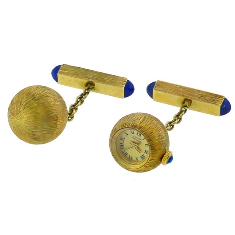 This amazing 14k yellow gold watch cufflinks by Lucien Piccard feature an elegant brush gold finish.
The bar is accentuated by sugarloaf cut lapis and the crown features a cabochon sapphire. It is signed and stamped 14K.

Inventory #43443PSSS