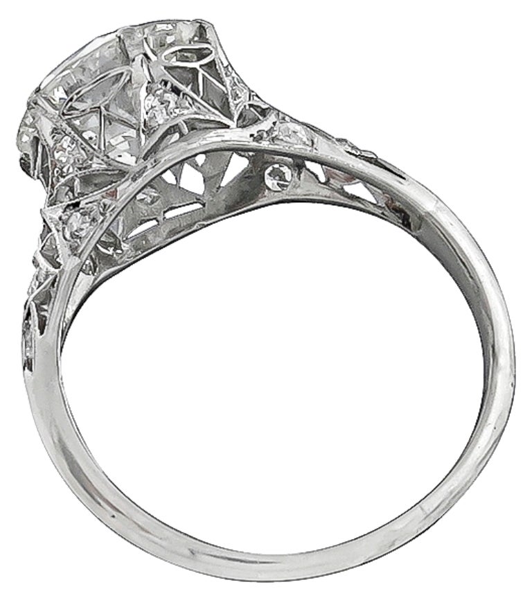 This stunning platinum ring from the Edwardian era, centers a sparkling GIA certified round brilliant cut diamond that weighs 3.61ct. The color of the diamond is J with SI1 clarity. The center diamond is accentuated by dazzling round cut diamonds