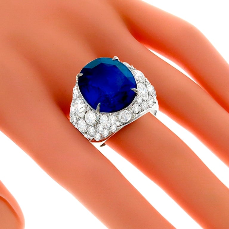 This stunning 14k white gold centers a 15.76ct oval cut sapphire. The center stone is accentuated by captivating old mine cut diamonds that weigh approximately 6.00ct. graded H color with VS clarity. 
The ring is size 11, and can be resized. 
The