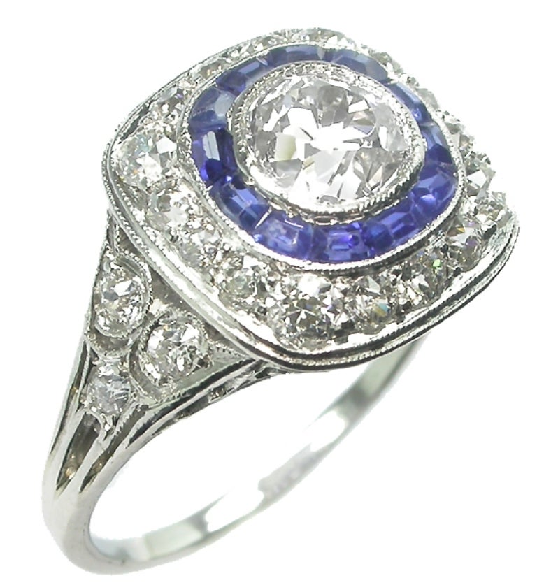 This gorgeous platinum ring  centers an EGL certified old European cut diamond that weighs 1.10ct. and is graded EGL F-G color with VS1 clarity. The center diamond is accentuated by dazzling old mine cut diamonds that weigh approximately 0.70ct. and