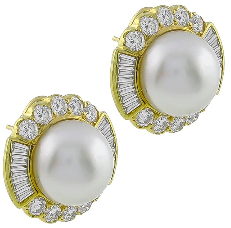 This gorgeous pair of 18k yellow gold earrings, feature lovely mabe pearls. The pearls are accentuated by sparkling round and baguette cut diamonds that weigh approximately 4.00ct. graded F color with VS1 clarity. 

The earrings are stamped