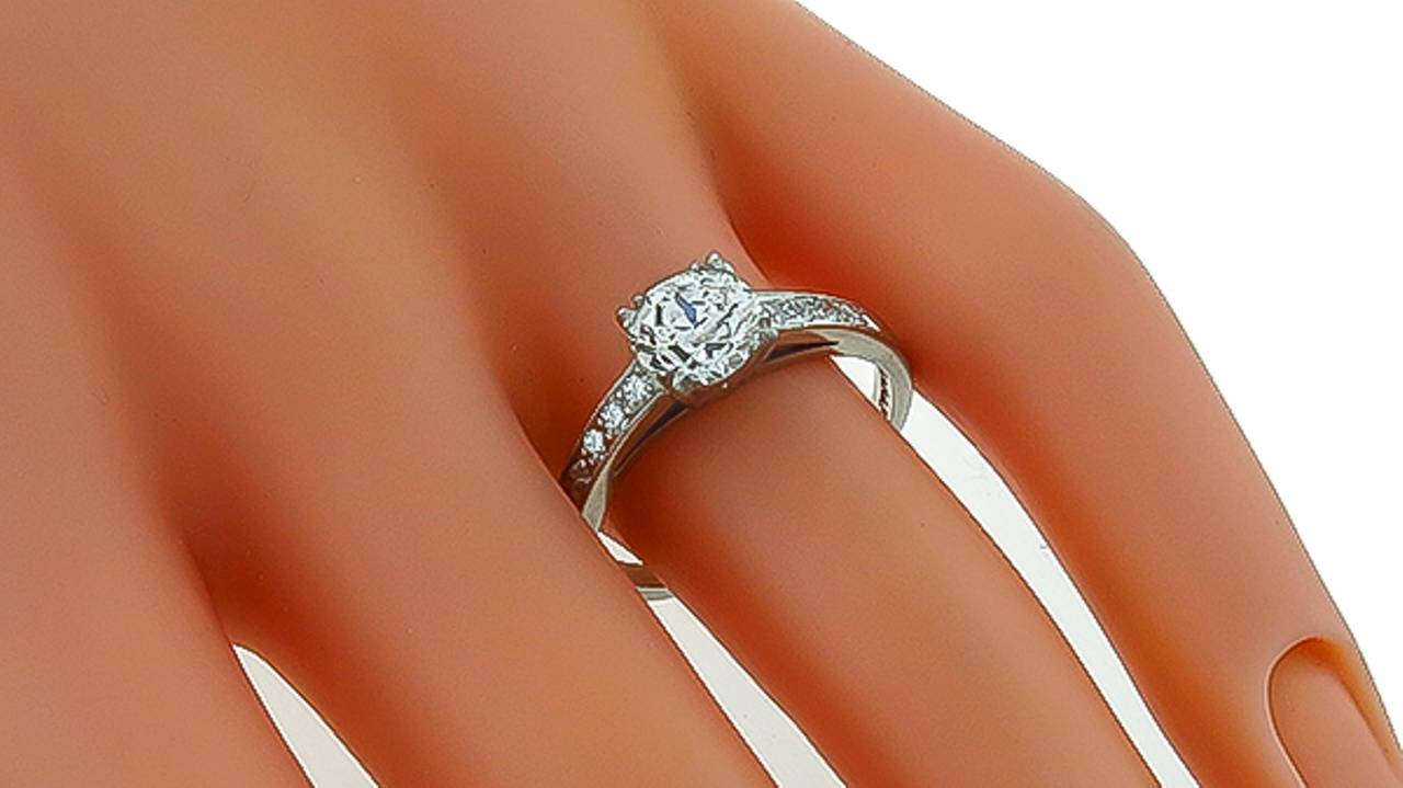This elegant platinum engagement ring is centered with a sparkling GIA certified old mine cut diamond that weighs 1.17ct. The color of the diamond is J with VVS2 clarity. The center stone is accentuated by old mine cut diamonds that weigh