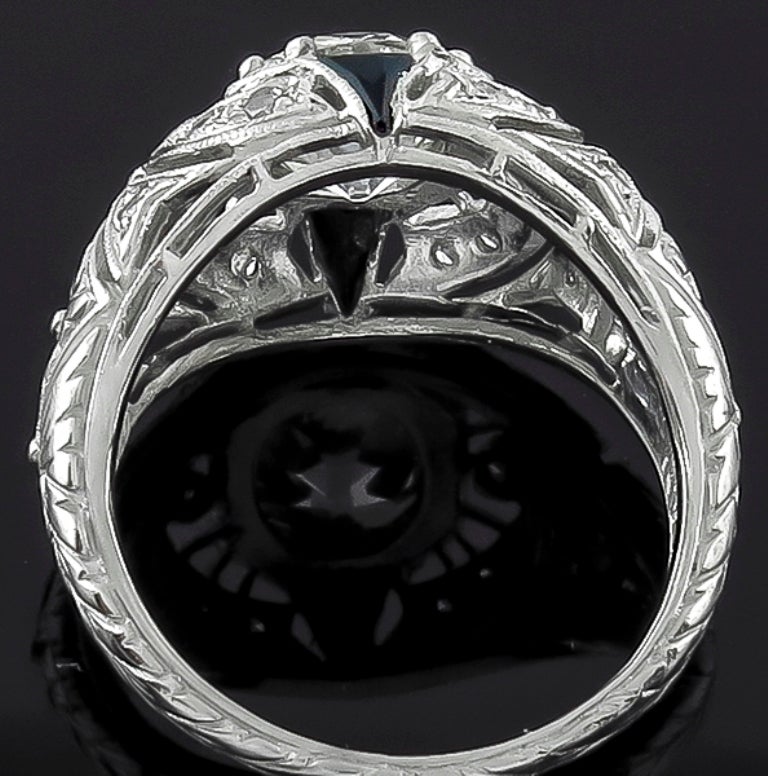 This amazing platinum ring centers a sparkling GIA certified old European cut diamond that weighs 1.89ct. and is graded K color with VS1 clarity. The center stone is accentuated by round cut diamond and triangular cut onyx accents. The top of the