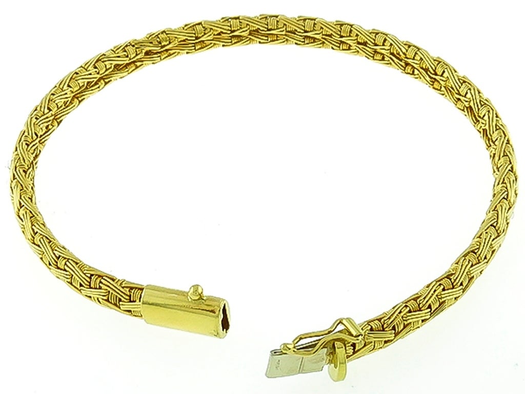Made of 18k yellow gold, this bracelet measures 5mm in width and 7 1/4 inches in length. It is stamped 18Kt ITALY and is numbered. 

Inventory #35729BBS