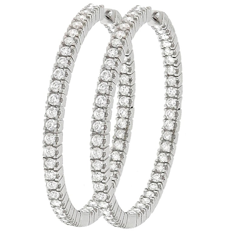 Made of 18k white gold, these earrings are inside-out set with sparkling round cut diamonds that weigh 2.48ct. graded H color with VS1 clarity. The hoops measures 38mm by 36mm with 3mm width; and weighs 13.7 grams.
They are stamped 18K 750