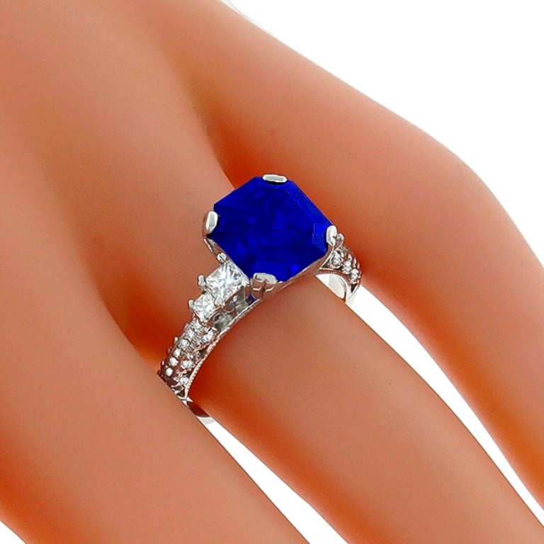 Made of 18k white gold, this ring centers a vivid blue asscher cut Ceylon sapphire that weighs 3.75ct. The center stone is accentuated by sparkling round cut diamonds that weigh approximately 0.50ct. The color of these diamonds is F with VS1