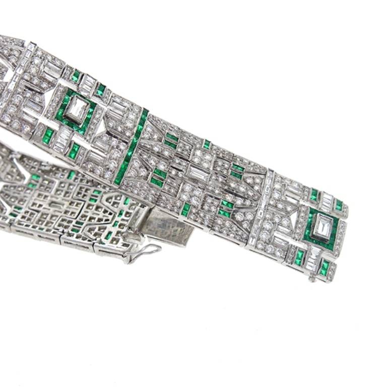 This gorgeous 18k white gold bracelet is set with approximate 12.00 carat of sparkling round and baguette cut diamonds, and 2.00 carat of bright emeralds.