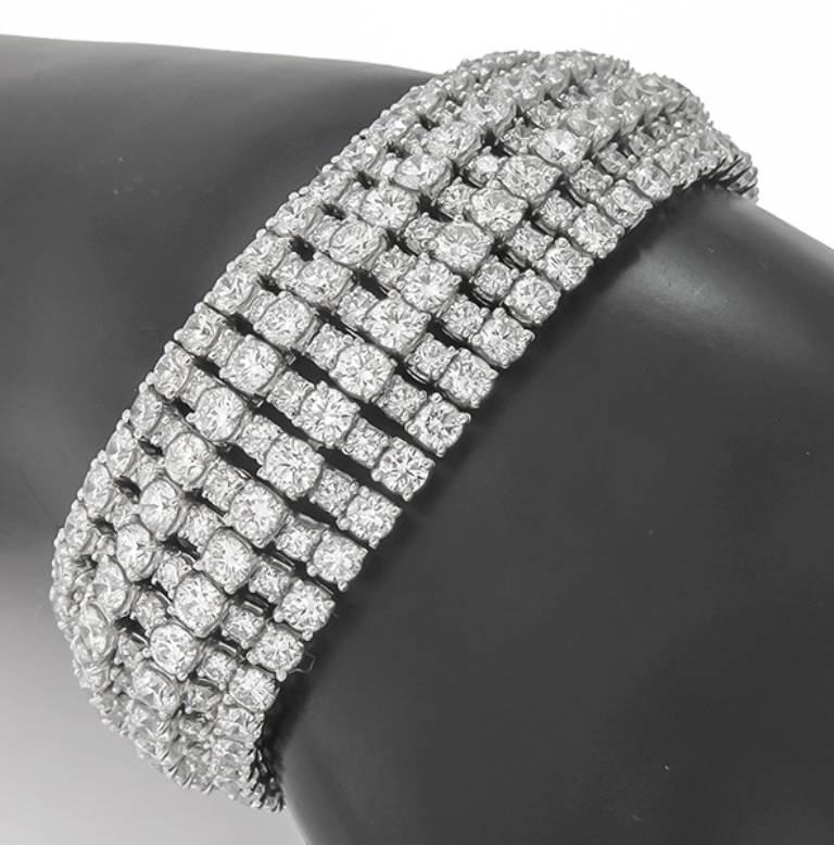 This stunning platinum bracelet is set with sparkling round cut diamonds that weigh approximately 53.00ct. The color of these diamonds is E-F with VS1 clarity. The bracelet measures 22mm in width and 7 1/4 inches in length. It weighs 102.9