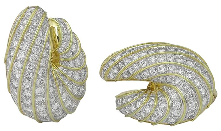 This stunning pair of 18k yellow and white gold earrings features high quality sparkling round cut diamonds weighing approximately 15.50 carat.
The color of the diamonds is E-F with VS1 clarity.
The earrings measure 38mm by 27mm and weigh 35