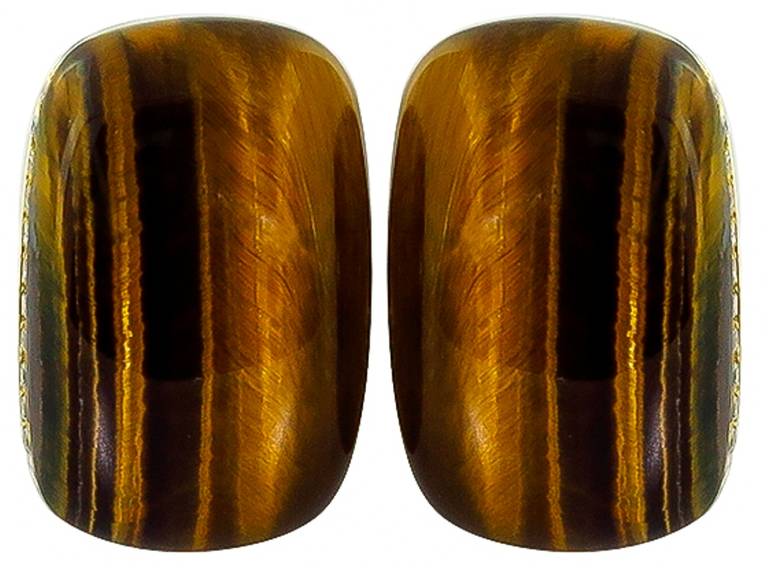 This pair of 18k gold tiger eye earrings is accentuated by approximately 1.50 carat of round cut diamonds. The earrings are stamped R COIN 750.

Inventory #48549EKS