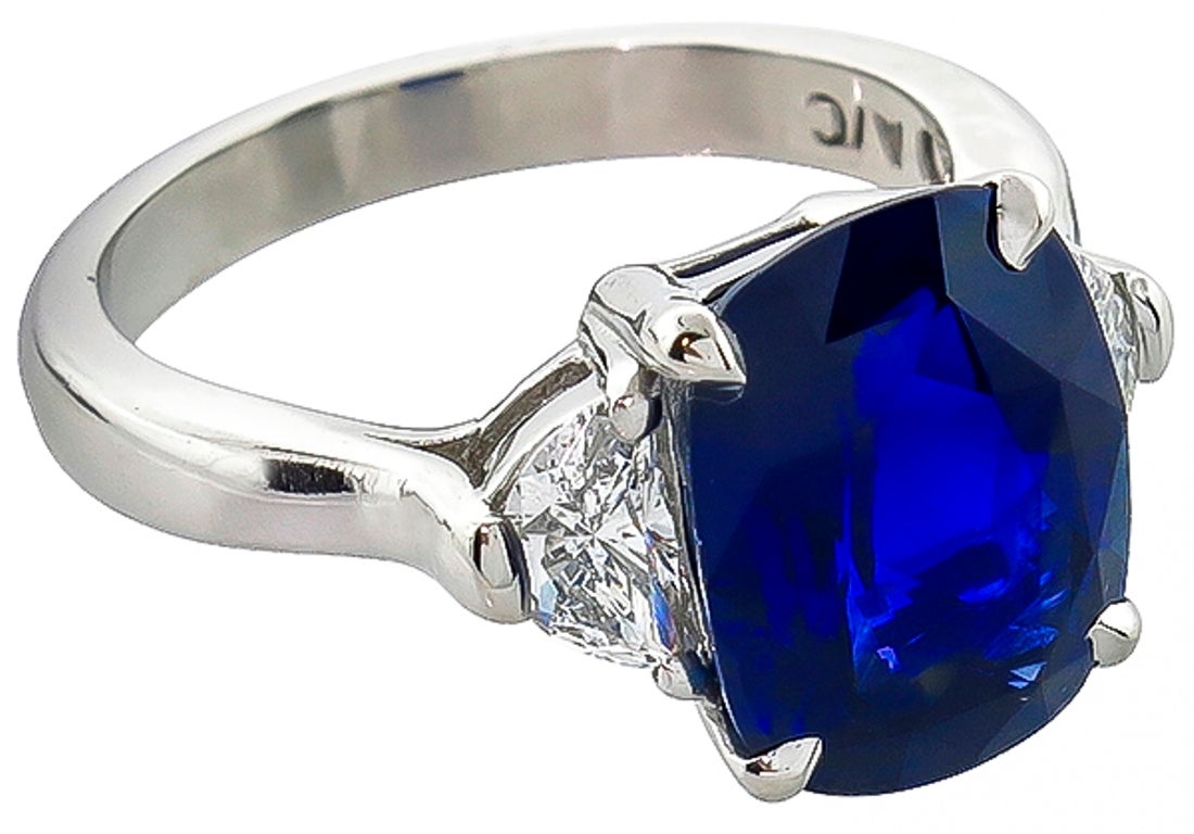 Made of platinum, this ring centers a cushion cut natural Ceylon sapphire that weighs 5.17ct. The sapphire is accentuated by sparkling half moon cut diamonds that weigh approximately 0.60ct. and are graded G color with VS clarity. The ring is