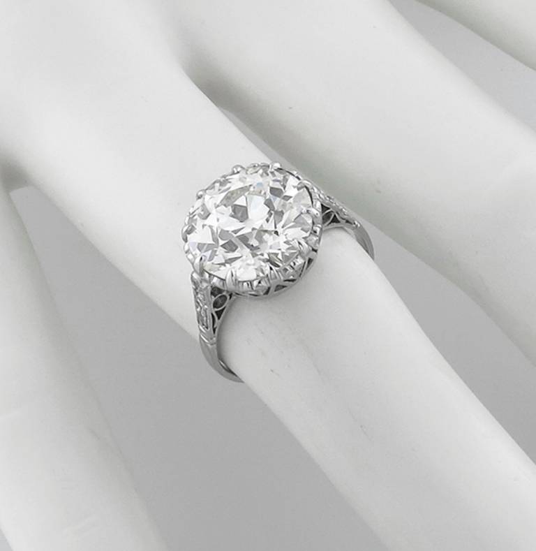 Made of 18k white gold, this ring from the Victorian era centers an EGL certified 5.65ct. sparkling old european cut diamond graded  H-I color with VS1 clarity. 
The top of the ring measures 12mm in diameter. Ring size is currently 6 1/2 and can be