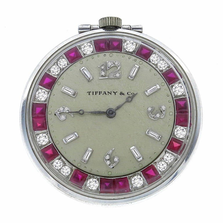 Made of platinum. this watch is set with bright red square cut rubies weighing approximately 3ct. and sparkling round cut diamonds that weigh approximately 3ct. graded F color with VS1 clarity. The watch measures 41.5mm in diameter, and weighs 51.1