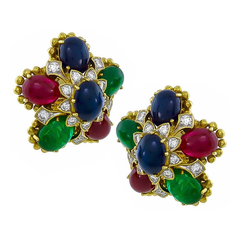 This is a beautiful pair of 18k yellow gold earrings. The earrings feature lovely cabochon rubies, sapphires and emeralds that weigh approximately 30.00ct. The colored stones are accentuated by sparkling round cut diamonds that weigh approximately