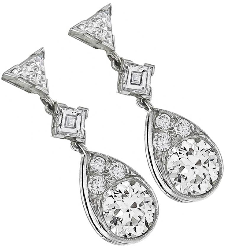 This beautiful pair of earrings are centered with 2 old European cut diamonds weighing approximately 2.45 carat. The color of these diamonds is H-I with VS clarity. The earrings also feature round, trilliant and square cut diamonds weighing