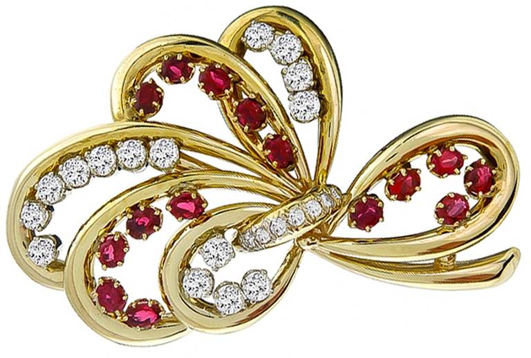 Made of 14k yellow gold, this pin is set with sparkling round cut diamonds weighing approximately 5.50ct. and bright red rubies weighing approximately 6 carat.

 
Inventory #9557PRBS