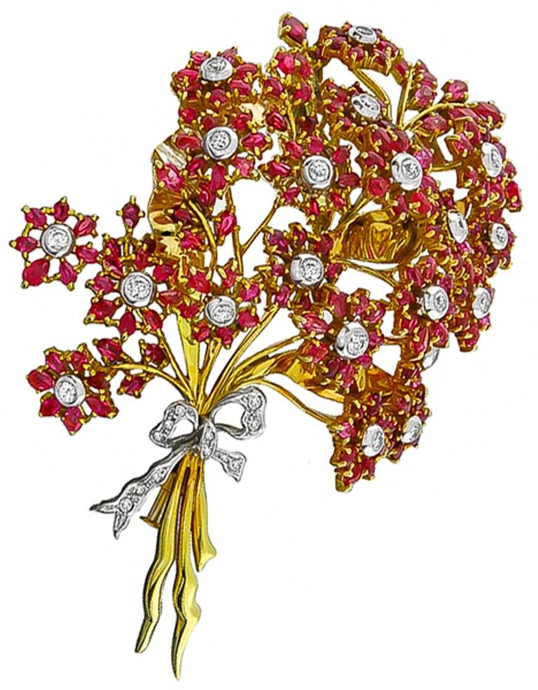 Made of 18k yellow gold and platinum, this pin is set with bright red marquise and pear cut rubies weighing approximately 35 carat. The pin also features round cut diamonds weighing approximately 2.30 carat.

 

Inventory #9022AASS