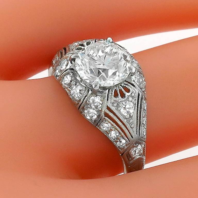 This platinum ring centers an EGL certified old European cut diamond that weighs 1.43ct. and is graded I-J color with VS2 clarity. The center stone is accentuated by round cut diamonds weighing approximately 0.50 carat. 
The ring is size 7, and can